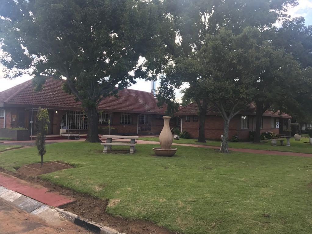 Lakama guest house — brick exterior with landscaped grounds